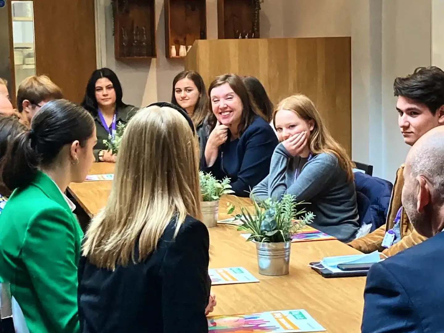 Dame Rachel de Souza at a long table with young adults