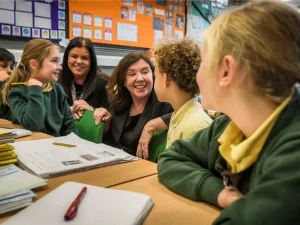 Dame Rachel de Souza chatting with young students at school
