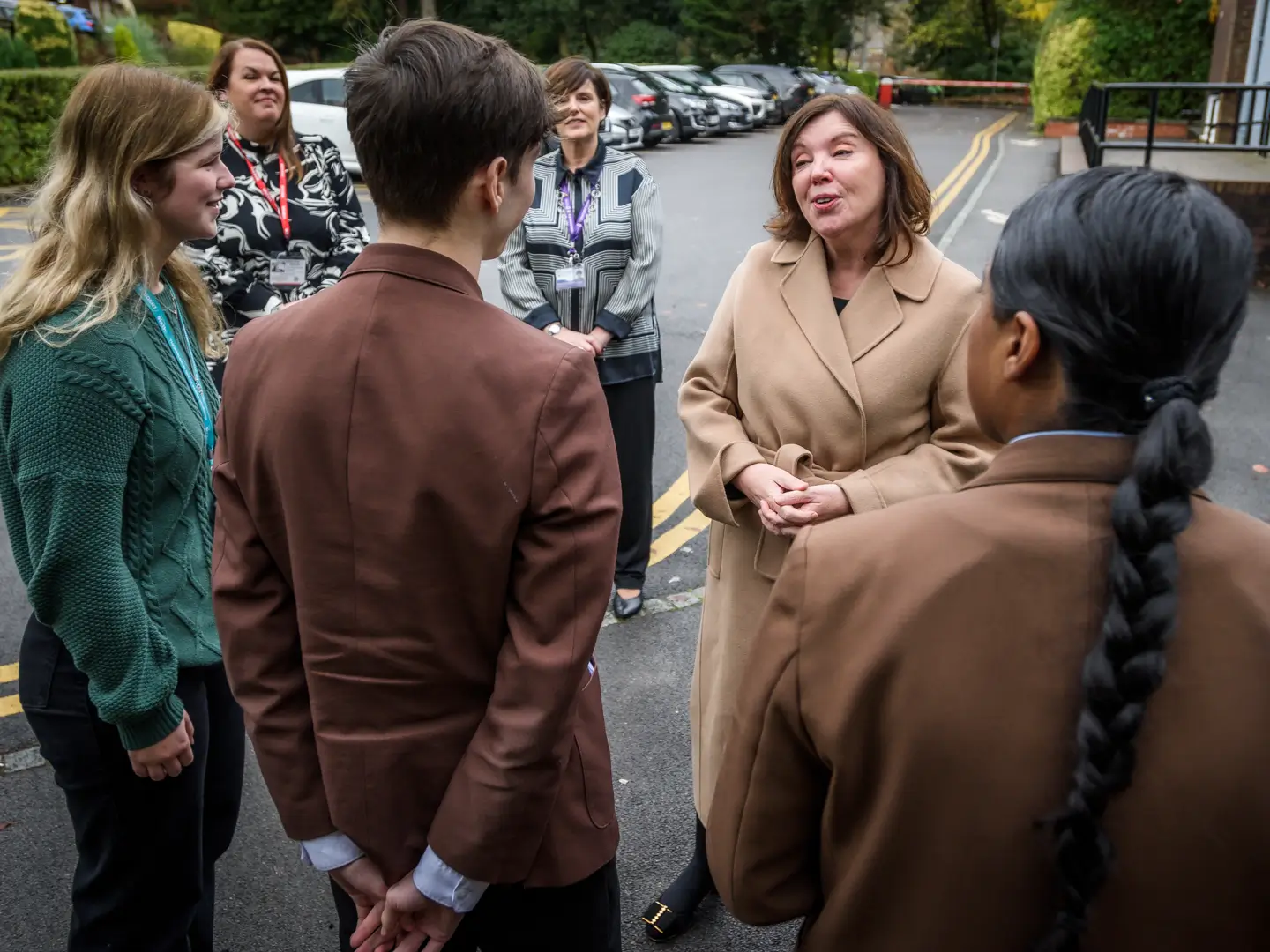 Dame Rachel de Souza speaking in a car park with teachers