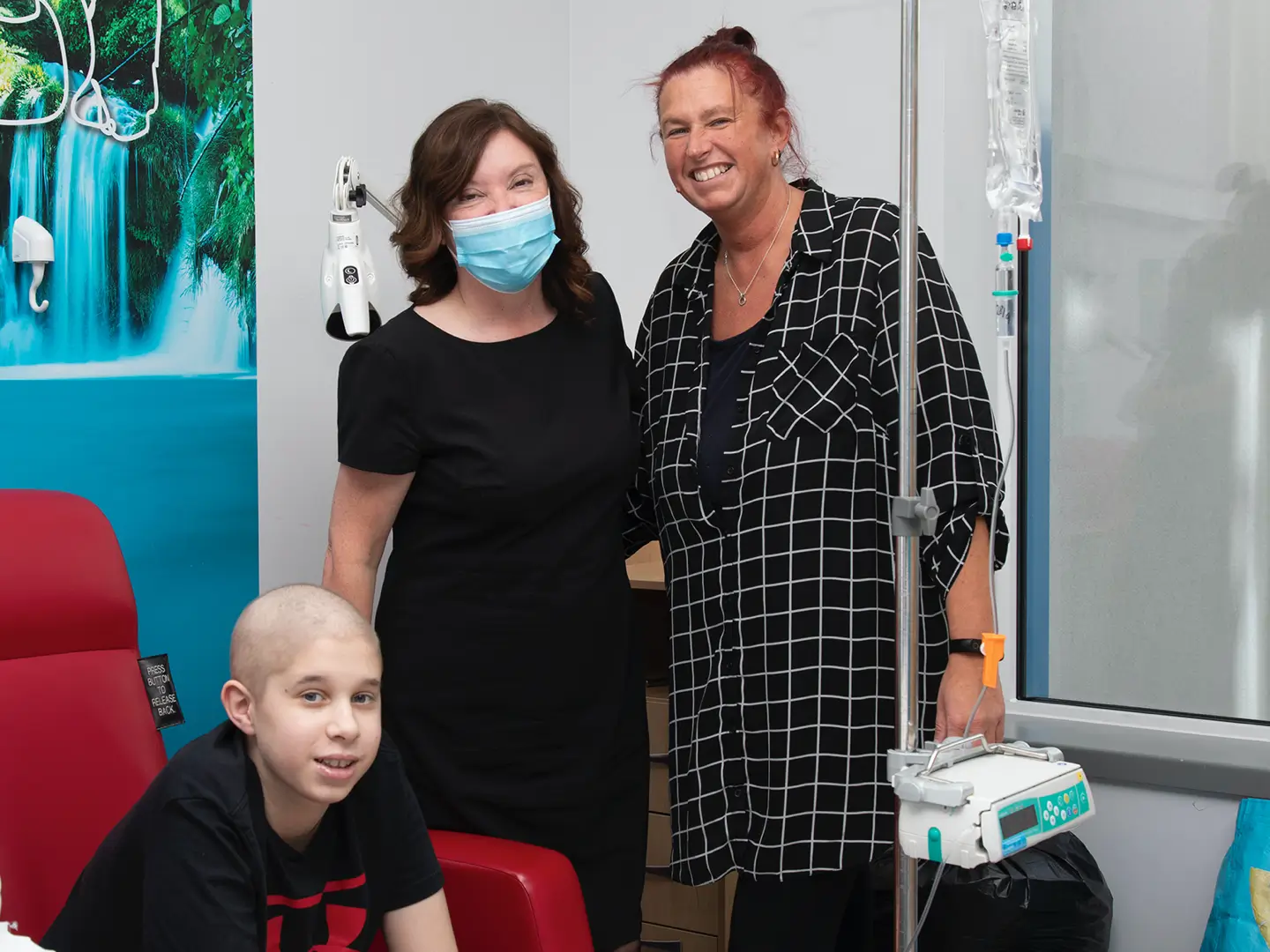 Dame Rachel de Souza standing with mother and child in hostpital
