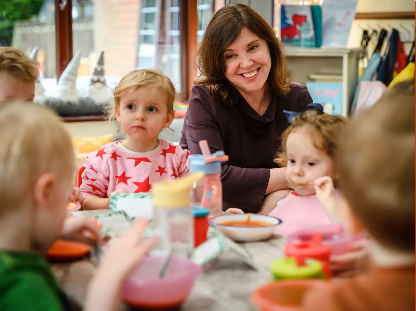 Dame Rachel de Souza sitting at the dinner table with a group of your children eating soup