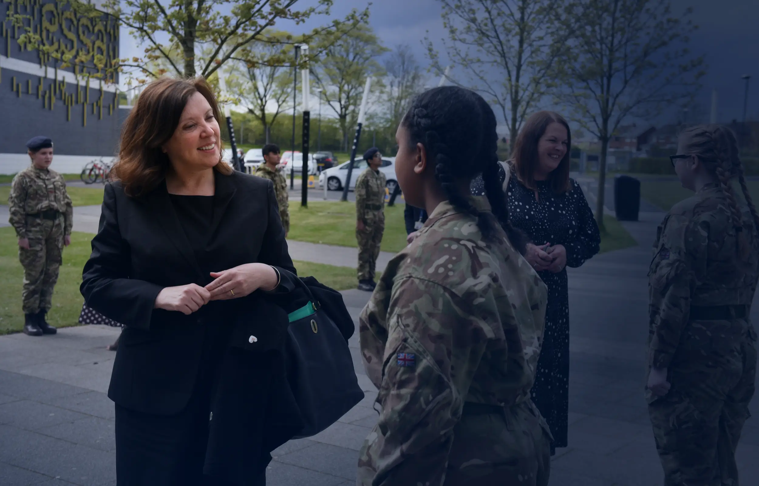 Dame Rachel de Souza talking to a young girl in a army uniform