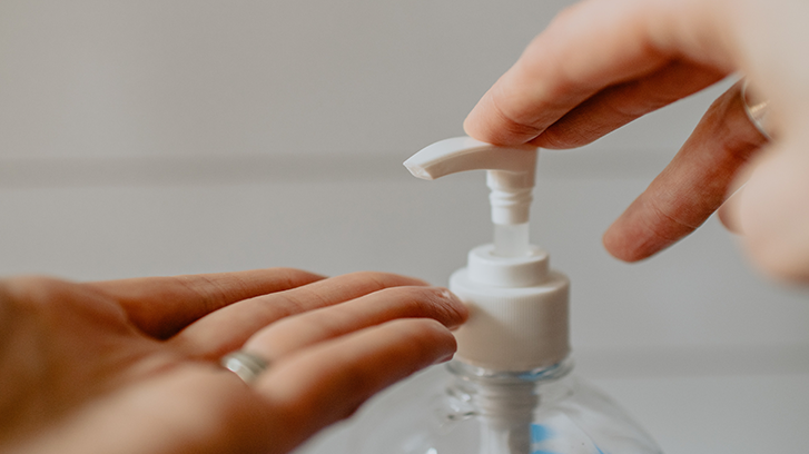 Image of person applying hand sanitiser.